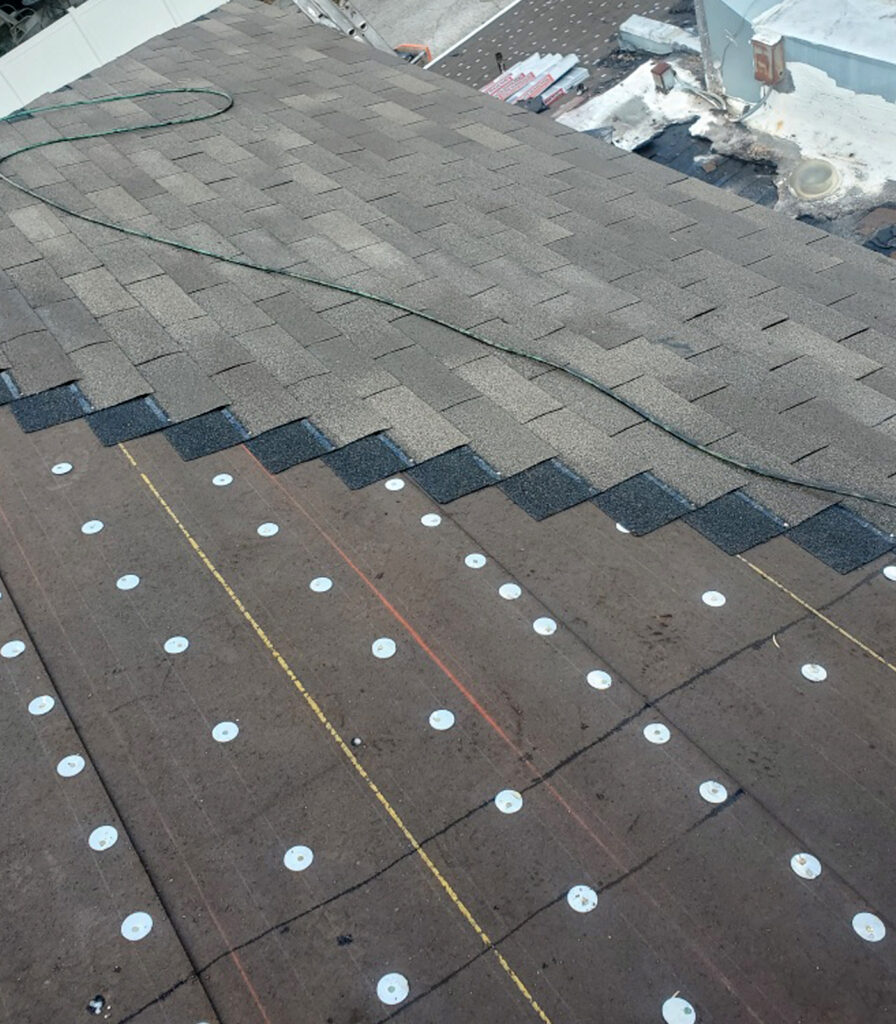 A top view of a shingle roof repair.