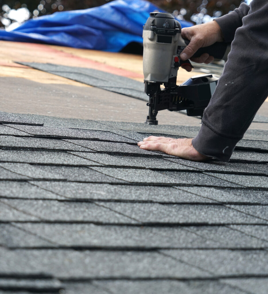 Worker repairing a damaged roof.