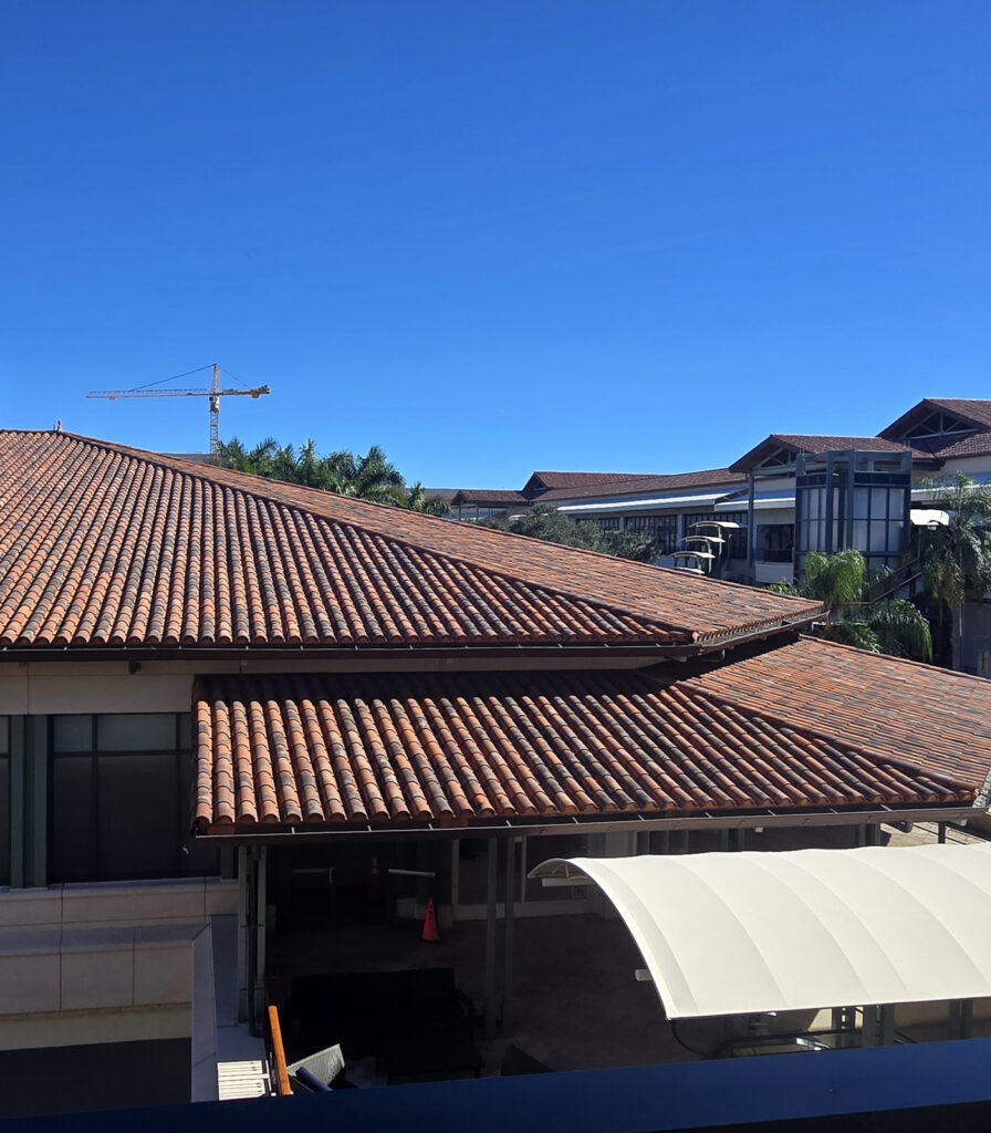 Slopped Spanish tile roof on a large house.